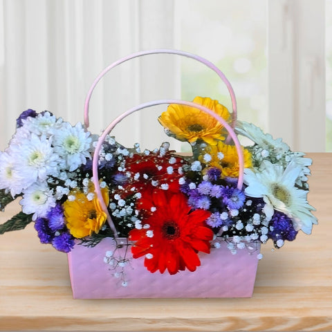 Florist Chennai - Pink basket filled with colourful blooms, vibrant flower arrangement Chennai